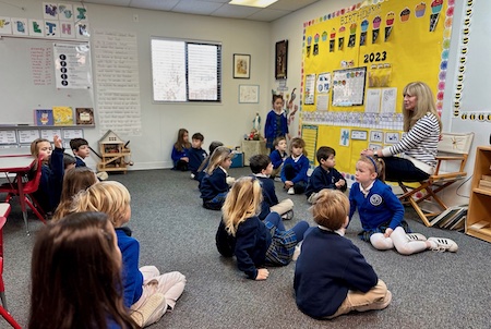 Children sitting on floor in classroom